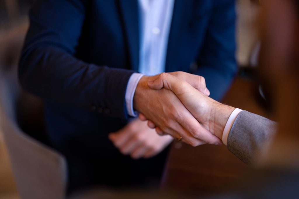 Poignée de main entre un client et un courtier en assurances lors d'un rendez-vous chez SRL Demanet à Mettet.