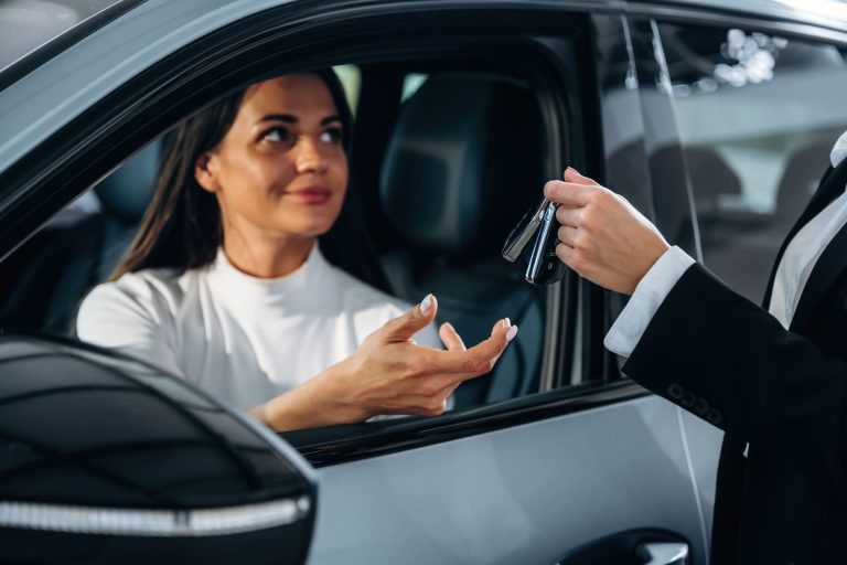 Remise des clés d'un véhicule à un client après la souscription d'une assurance auto.